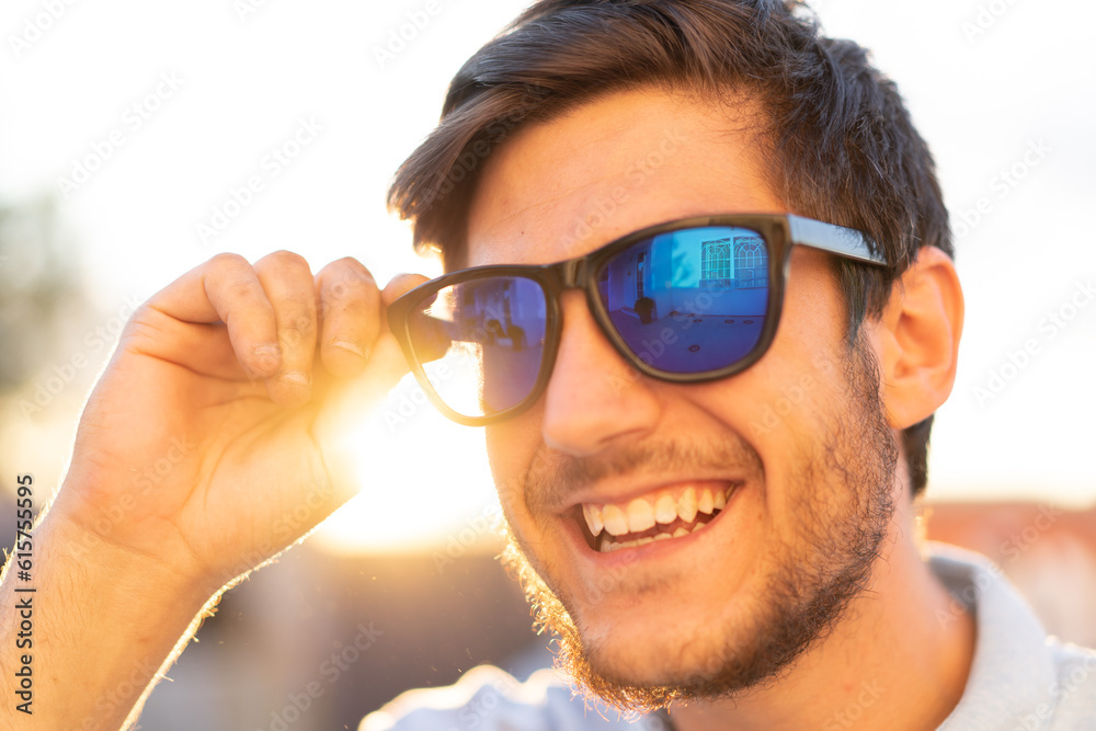 Portrait of a young man with glasses: A sunlit day frames the confident gaze of a stylish young man, capturing his youthful charm. Portrait of a young man with glasses: A sunlit day frames the confident gaze of a stylish young man, capturing his youthful charm.