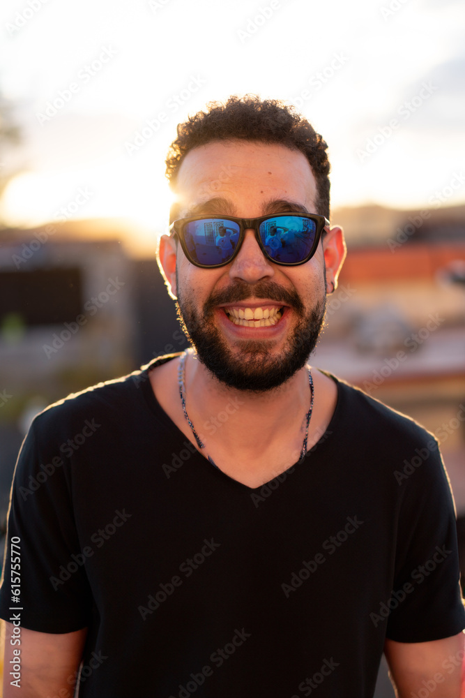 Portrait of a young man with glasses: A sunlit day frames the confident gaze of a stylish young man, capturing his youthful charm. Portrait of a young man with glasses: A sunlit day frames the confident gaze of a stylish young man, capturing his youthful charm.