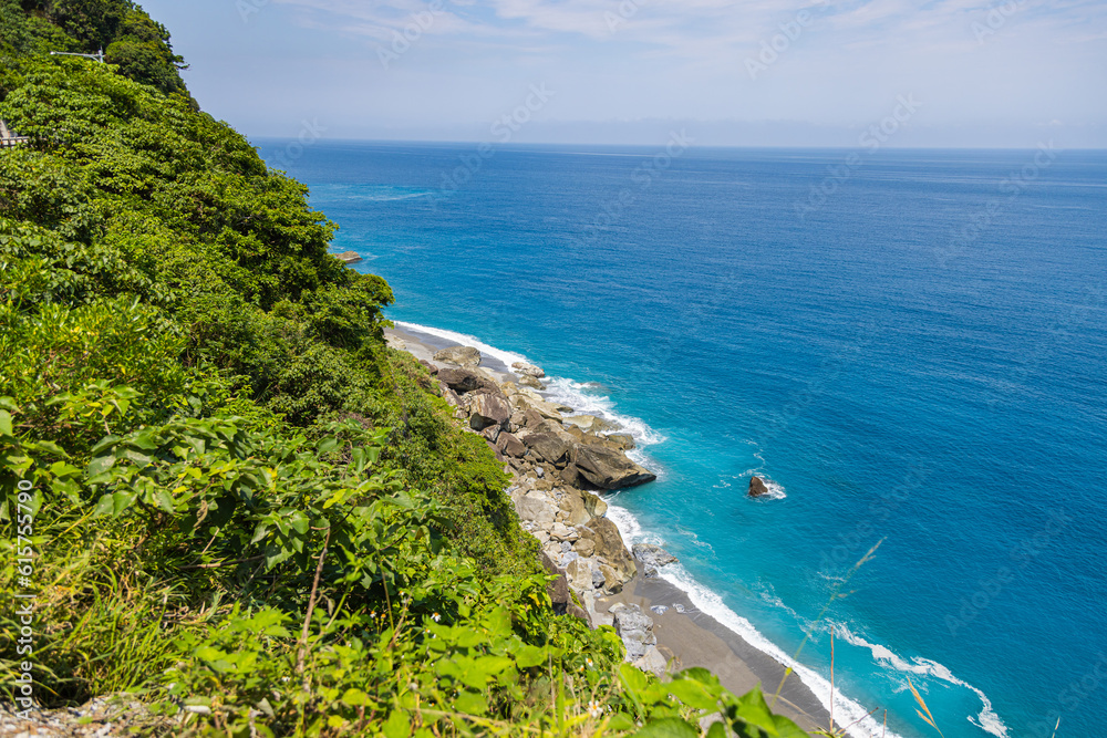 Stunning view reveals the grandeur of the cliffs at Taiwan southeast coast, Qingshui Cliff near Taroko National Park. Towering and lush, they overlook the azure sea, evoking a sense of awe. Landscape