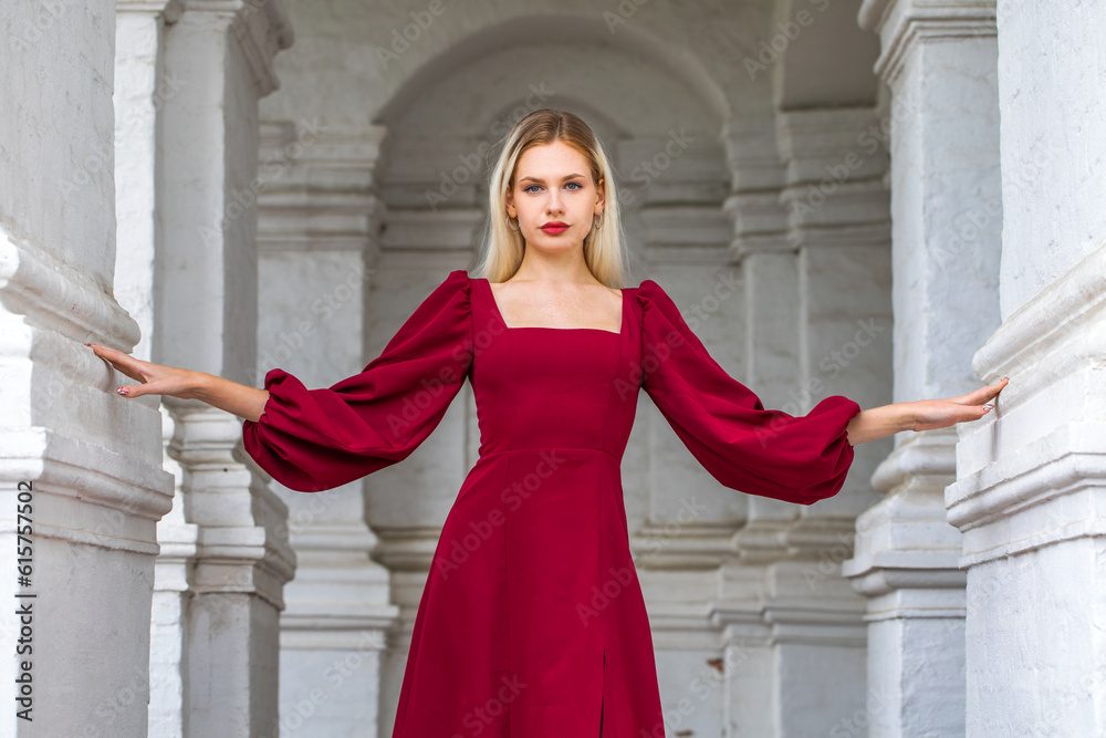 Φωτογραφία Portrait of a young beautiful blonde girl in an evening burgundy dress
