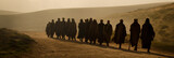apostles are going to preach in the Judean desert. Men walk across a sandy landscape