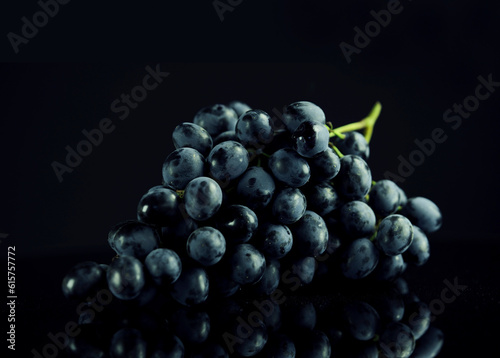 bunch of ripe dark grape isolated on black background