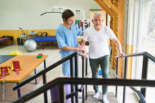 Physiotherapist assisting elderly man in movement therapy photo