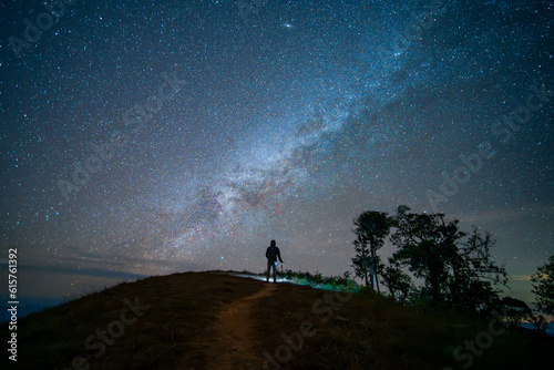 A man standing in the top of mountain with plenty of star in the sky (Chiang mai province, Thailand). amazing natural landscape. popular attractions best famous tourist attractions