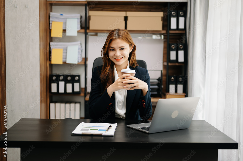 Business asian woman using tablet and laptop for doing math finance on an office desk, tax, report, accounting, statistics, and analytical research concept in office Business asian woman using tablet and laptop for doing math finance on an office desk, tax, report, accounting, statistics, and analytical research concept in office
