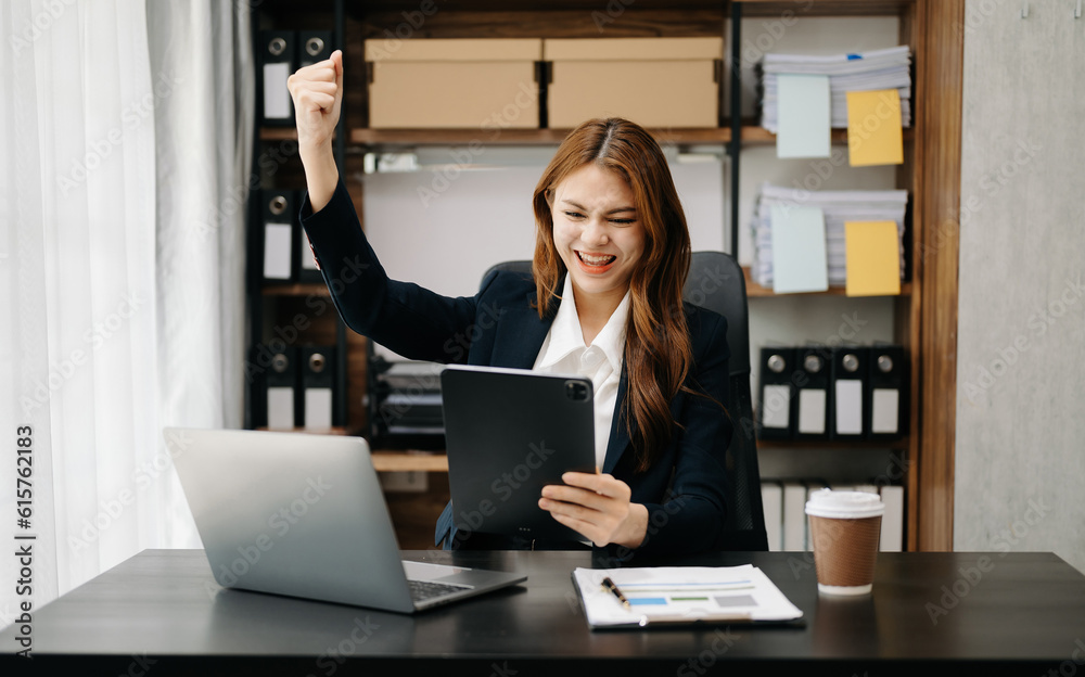 Asian business woman are delighted and happy with the work they do on their tablet, laptop and taking notes at office.. Asian business woman are delighted and happy with the work they do on their tablet, laptop and taking notes at office..