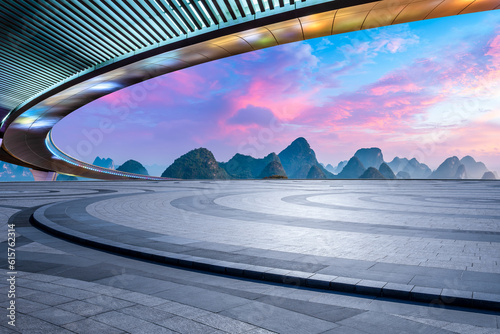 Empty square floor and bridge with karst mountain natural scenery at sunrise
