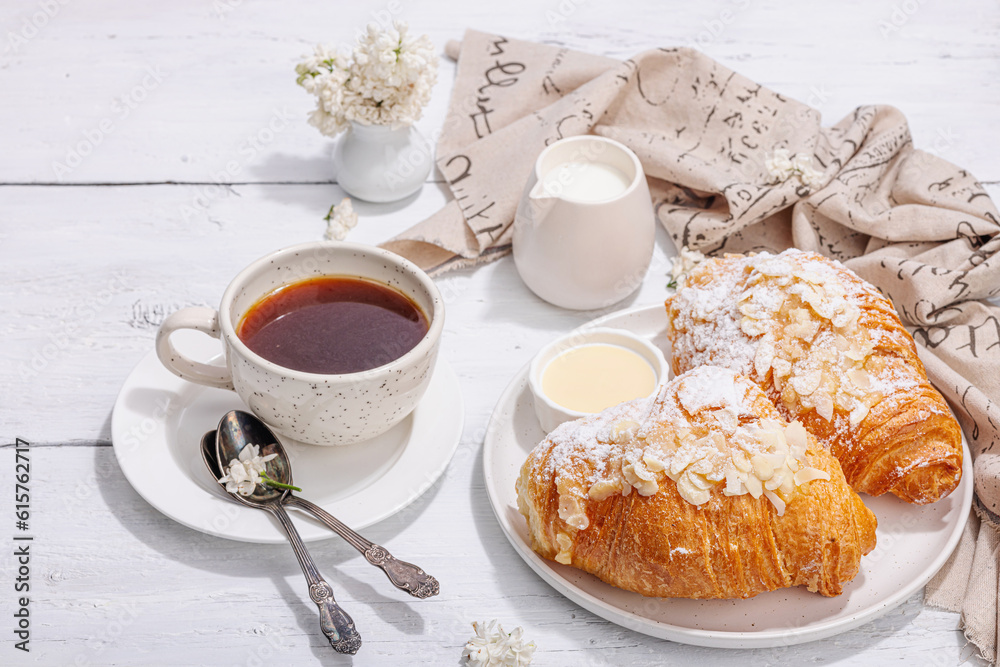 Good morning concept. Breakfast with cup of coffee and fresh croissant. Sweet creamy sauce Good morning concept. Breakfast with cup of coffee and fresh croissant. Sweet creamy sauce