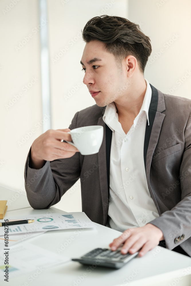 Portrait of businessman sitting at office desk, looking to the left. Portrait of businessman sitting at office desk, looking to the left.