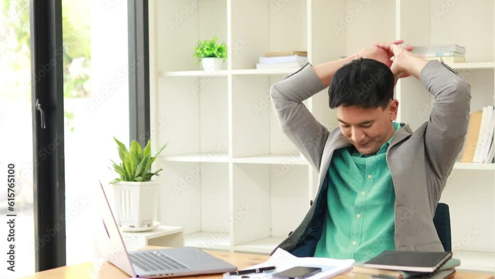 Man sitting in company office, start-up worker working hard, his body aches after working long hours causing a condition known as office syndrome. The concept of office syndrome. Man sitting in company office, start-up worker working hard, his body aches after working long hours causing a condition known as office syndrome. The concept of office syndrome.