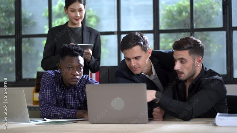 group of happy multi-ethnic business people meeting with laptop computer on table in office. diversity team building young worker discussion together. african american asian caucasian group of happy multi-ethnic business people meeting with laptop computer on table in office. diversity team building young worker discussion together. african american asian caucasian