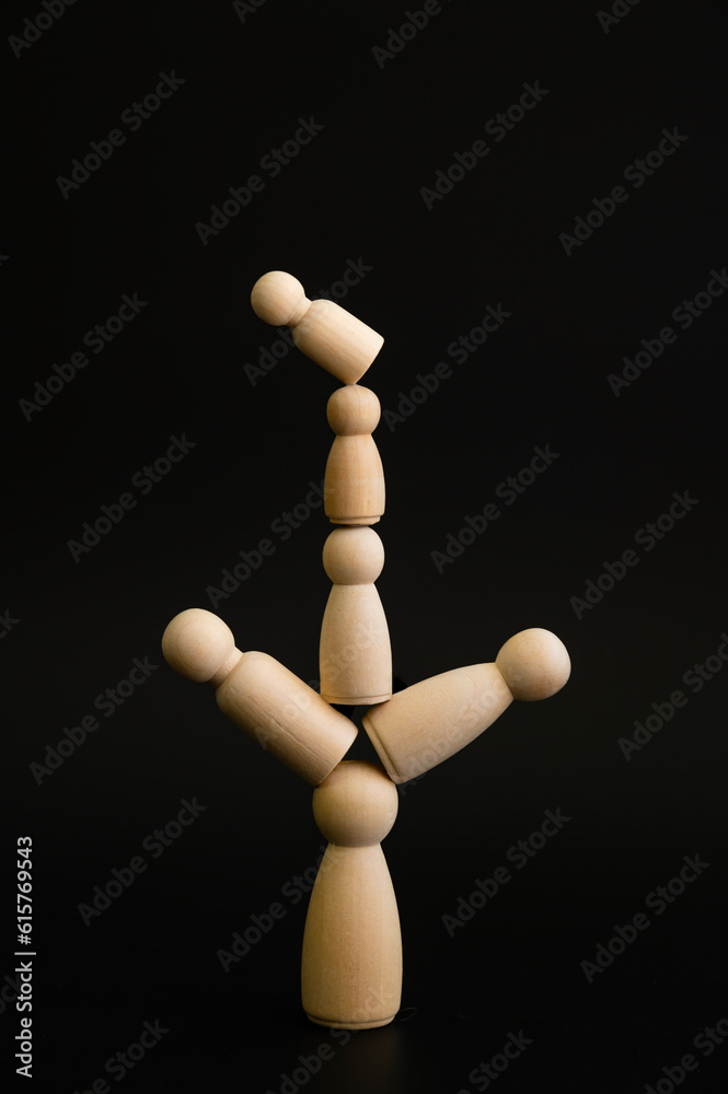 Person on stacked wooden blocks concept of balance or imbalance Person on stacked wooden blocks concept of balance or imbalance