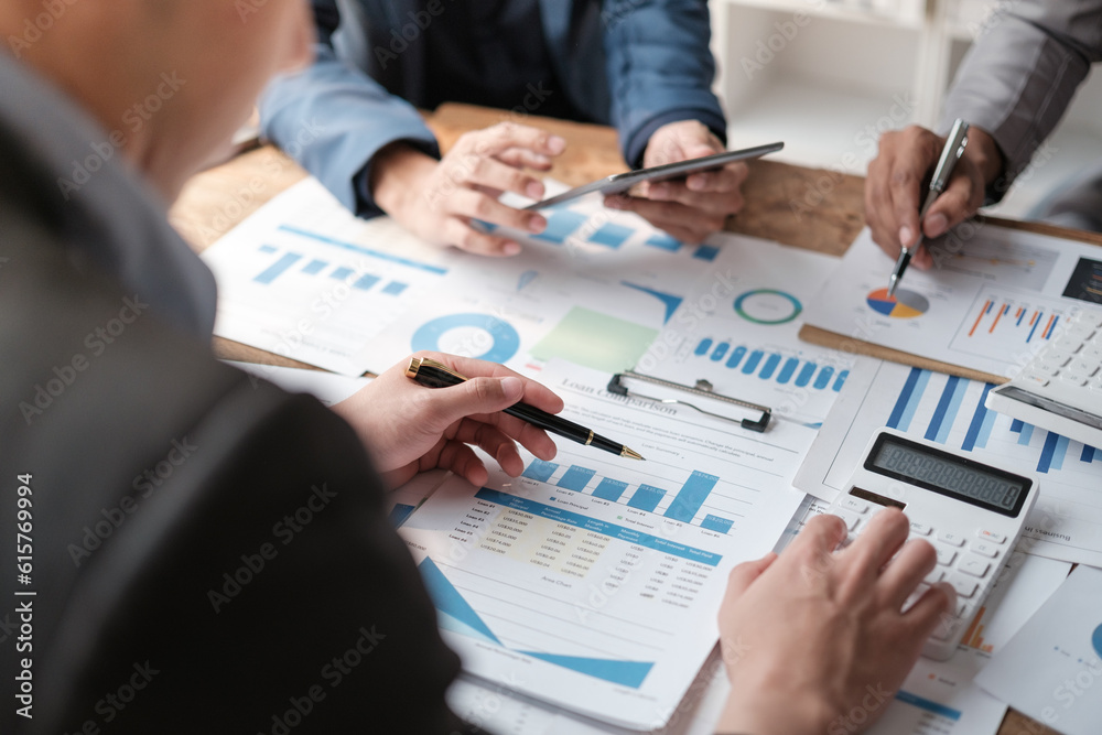 Close up group of business men and woman discussion and brainstorming, bookkeeping audit graph and chart documents at desk, teamwork concept. Close up group of business men and woman discussion and brainstorming, bookkeeping audit graph and chart documents at desk, teamwork concept.