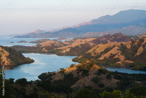Landscape, view of bays and islands with mountains covered with dry, yellow grass, Flores, Indonesia.