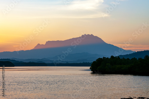 Beautiful sunrise over Mt Kinabalu and Mengkabong Gayang river Sabah Borneo Malaysia photo
