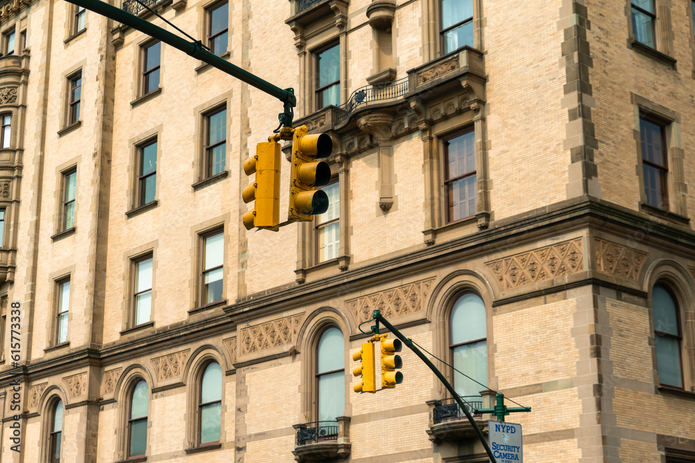Traffic light signal in the city. American style yellow traffic light in New York City. Traffic in the city. Background with classical buildings. Traffic light signal in the city. American style yellow traffic light in New York City. Traffic in the city. Background with classical buildings.