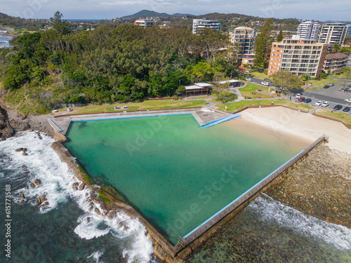 Aerial view of a calm ocean bath next a beach and waterfront property photo