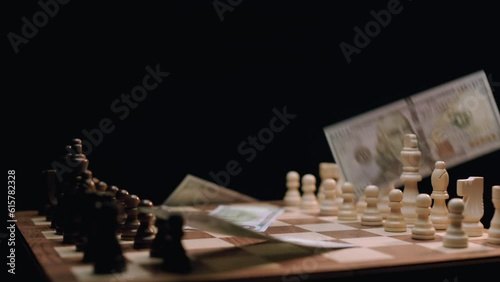 Cash Falling on Rotating Chess Board. Shot with ARRI Alexa in ArriRaw at 120 fps, exported 23.98 fps QuickTime Apple ProRes 422 HQ. photo