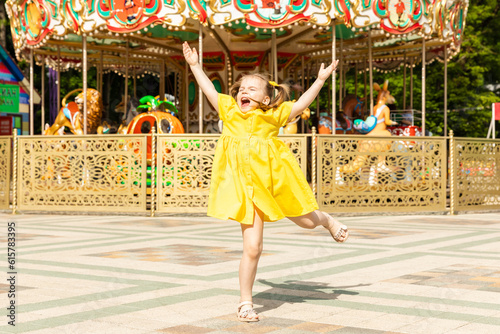 Cute little girl having fun on a playground outdoors in summer. Little girl having fun in amusement park © Irina Mikhailichenko