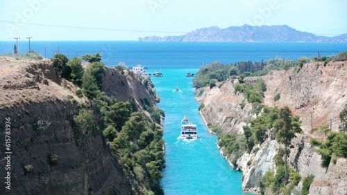 Pleasure boat floats among the rocks in turquoise water of Corinth Canal.
Beautiful scenery of the Corinth Canal in a bright sunny day against a blue sky, Greece