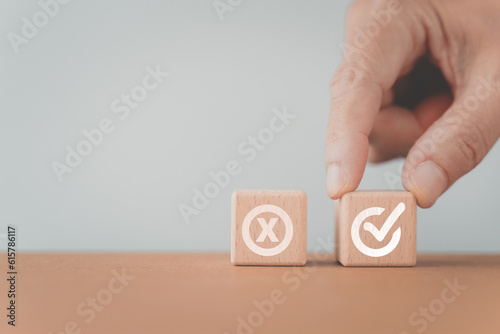 hand choose approved sign on wooden cube block, True and false symbols accept rejected for evaluation