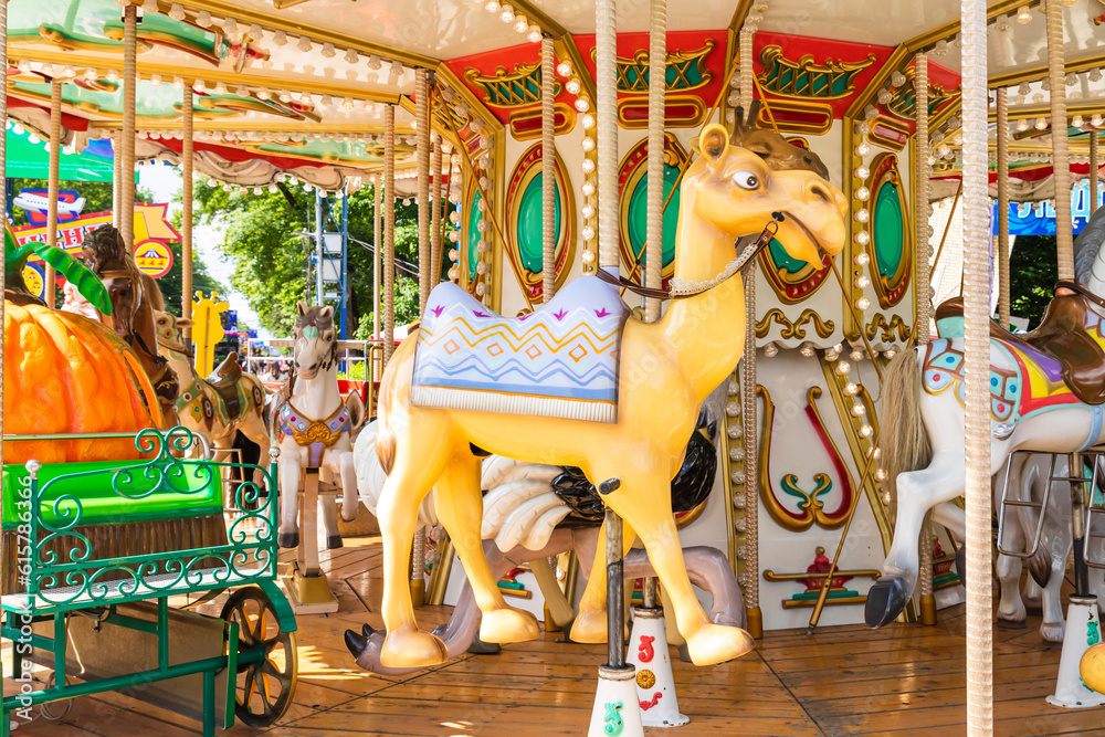 Carousel in an amusement park. Merry go round. The concept of summer holidays and school holidays
