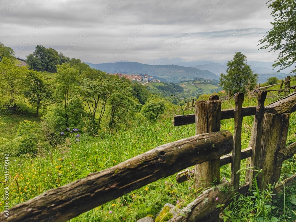 View of a valley and mountain panorama with a historic wooden fence in the foreground