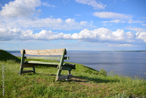 viewpoint with wooden bench on the river bank, copy space 