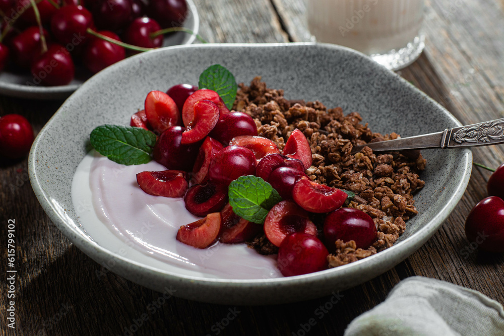 Granola with yogurt and cherries in a bowl
Granola with yogurt and cherries in a bowl