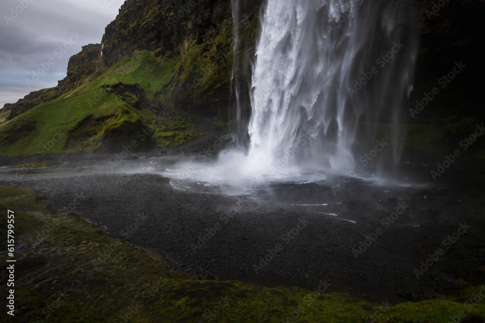 Seljalandsfoss waterfall in south iceland from the side, wild water falling in front of a cave