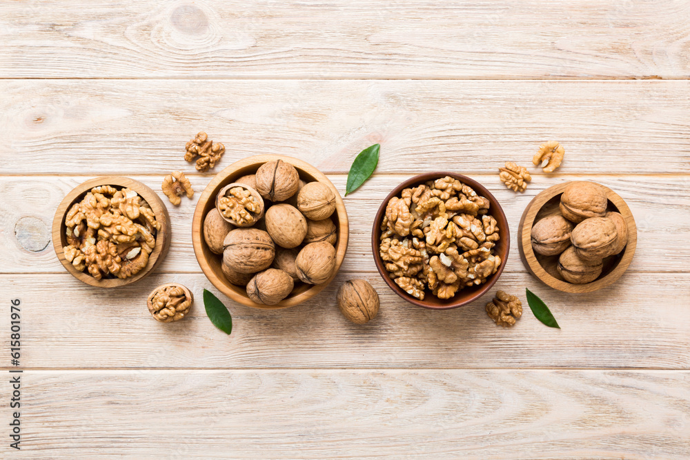 Walnut kernel halves, in a wooden bowl. Close-up, from above on colored background. Healthy eating Walnut concept. Super foods with copy space Walnut kernel halves, in a wooden bowl. Close-up, from above on colored background. Healthy eating Walnut concept. Super foods with copy space