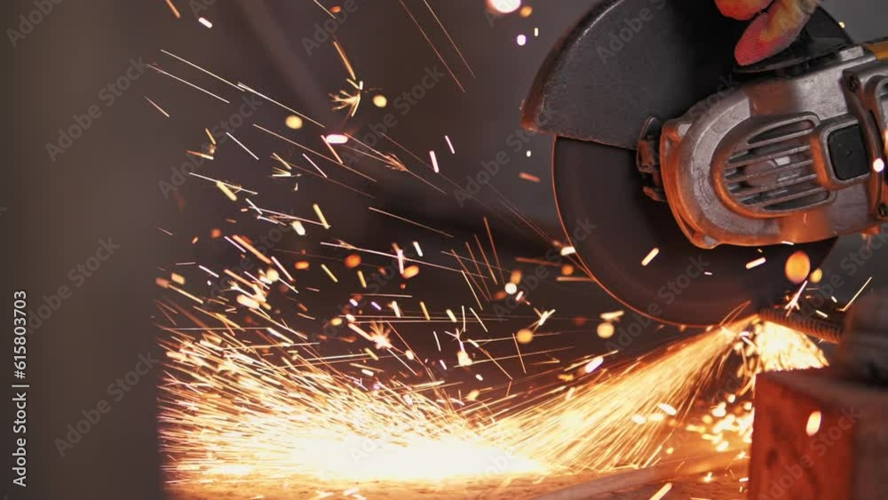 Metal is cut with a grinder, sparks fly.