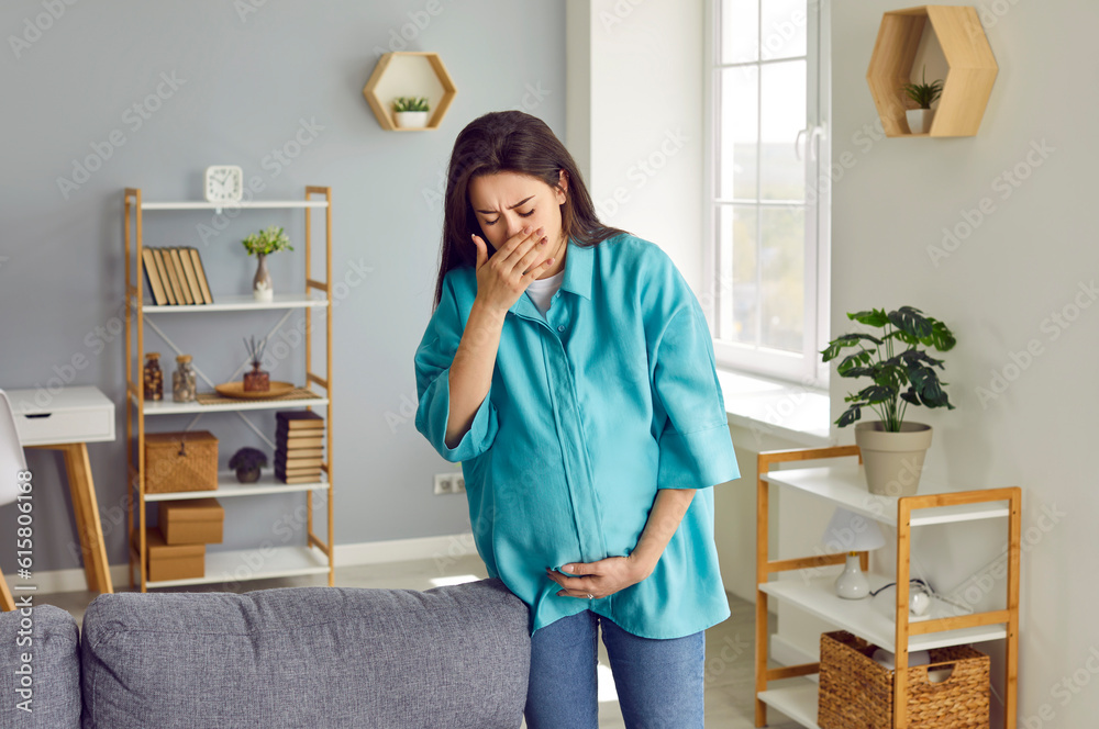 Foto de Pregnant woman suffers from morning sickness. Young lady