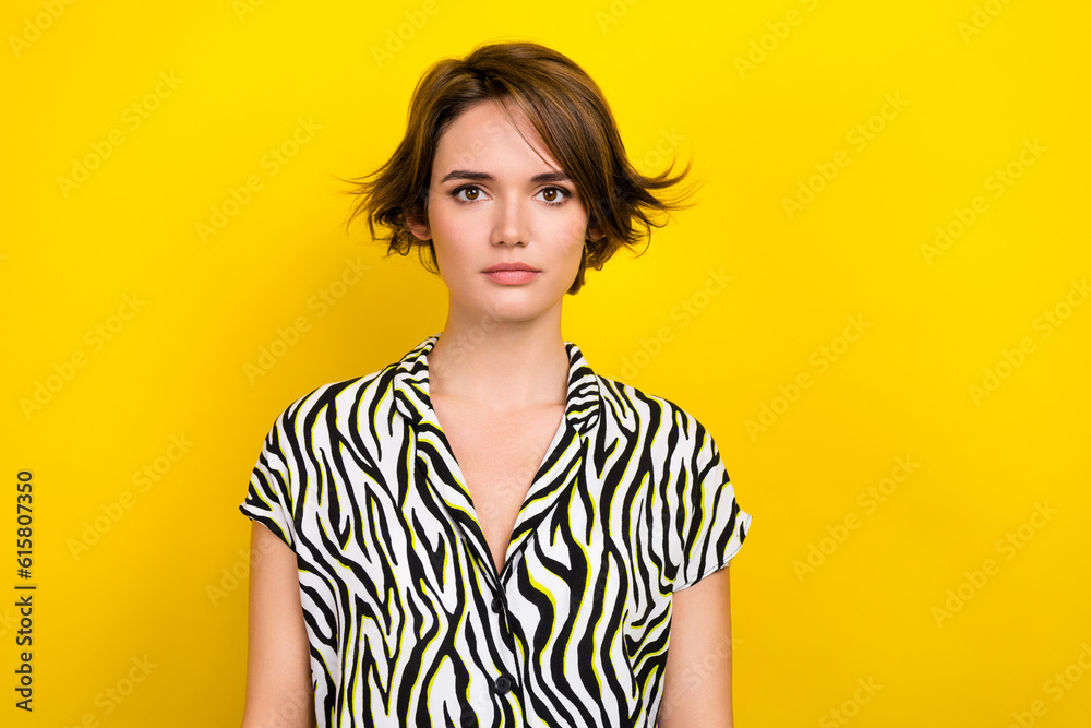 Portrait of attractive girl worker indifferent facial expression wear zebra striped summer blouse isolated yellow color background Portrait of attractive girl worker indifferent facial expression wear zebra striped summer blouse isolated yellow color background