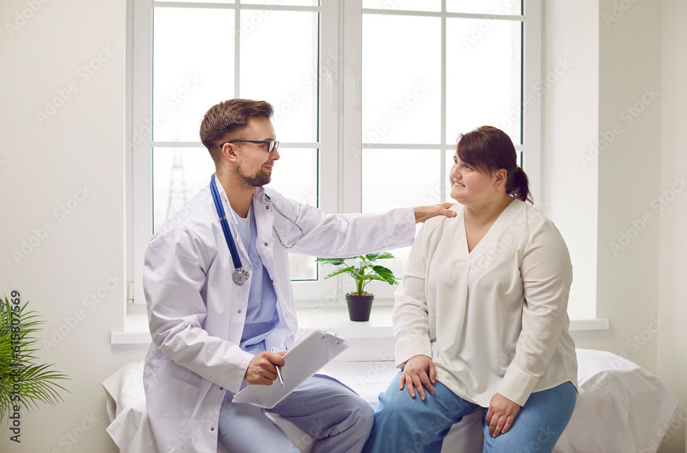 Overweight woman at doctor's office sitting on the couch. Doctor holding report file with appointment and giving consultation to a fat patient during medical examination in clinic supporting her. Overweight woman at doctor's office sitting on the couch. Doctor holding report file with appointment and giving consultation to a fat patient during medical examination in clinic supporting her.
