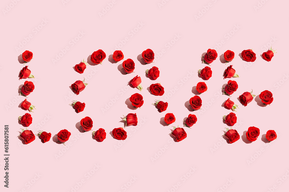 Creative layout with red roses and Word LOVE. Love or Valentine's Day concept. Flat lay.