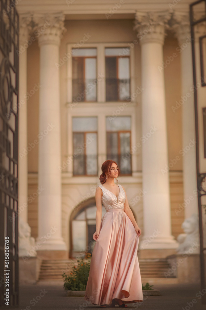 Beautiful slender girl in an evening dress. Prom. Graduate. Schoolgirl. Student. Girl with long red hair. Portrait of a girl. Girl dancing. Tenderness. Fashionable girl.