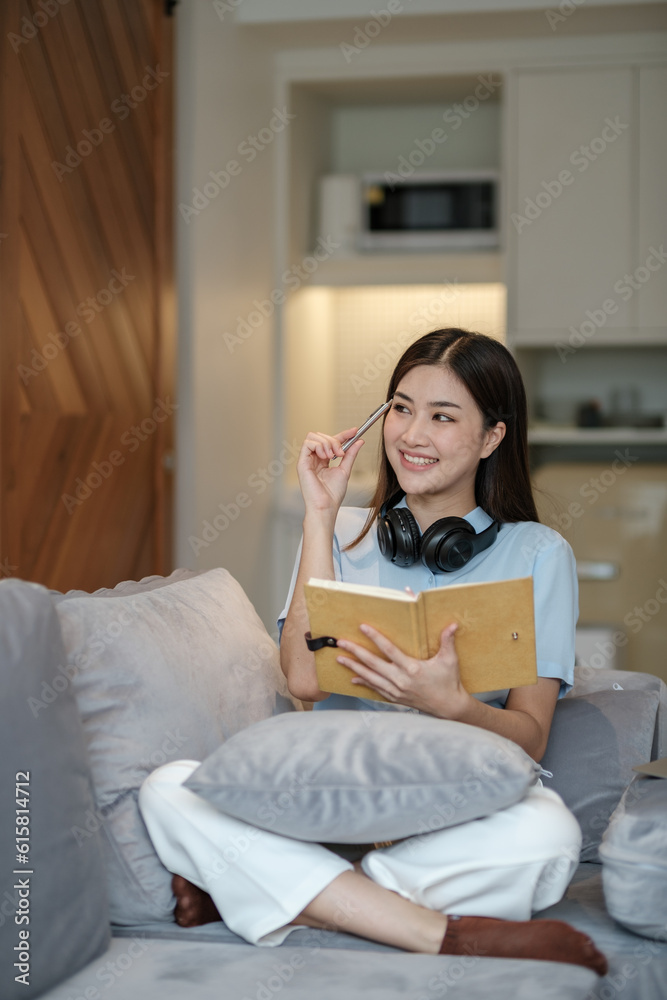 Beautiful asian woman online learning with laptop in living room. Beautiful asian woman online learning with laptop in living room.