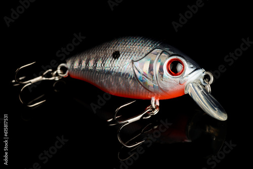 Plastic fishing lure - rattler crank isolated on black photo