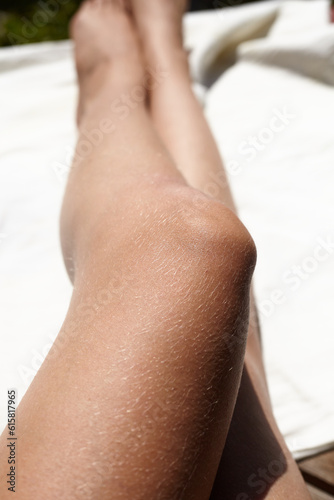 slender  tanned female legs with hair. The theme of self-acceptance and body positivity