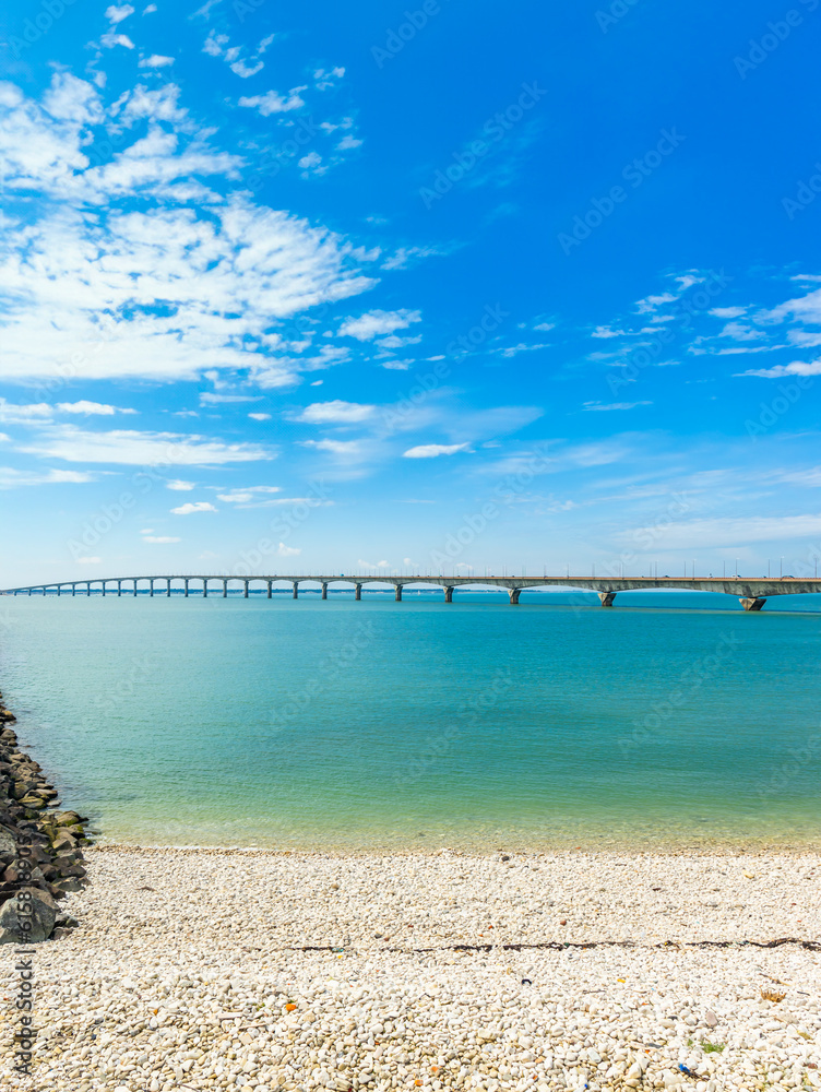 Scenic view of the Ile de Ré bridge seen from La Rochelle shore on a sunny day in Charente-Maritime, France