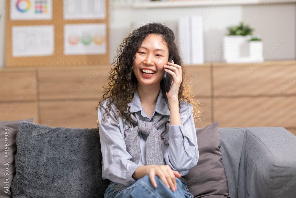 Asian young woman answer the phone and talking with positive and happiness emotional.Attractive female talkin in smartphone smile and cheeful with good news and good moment at home Asian young woman answer the phone and talking with positive and happiness emotional.Attractive female talkin in smartphone smile and cheeful with good news and good moment at home