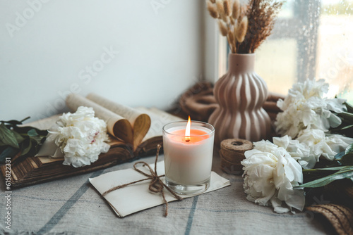 Burning candle and white peonies  vintage aesthetic