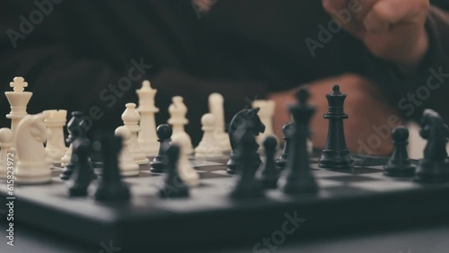 Elderly man learning to play chess alone, senior lifestyle, retirement hobby
