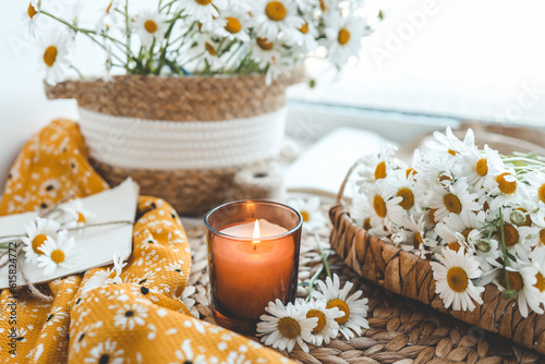 Candle and daisies, summer composition