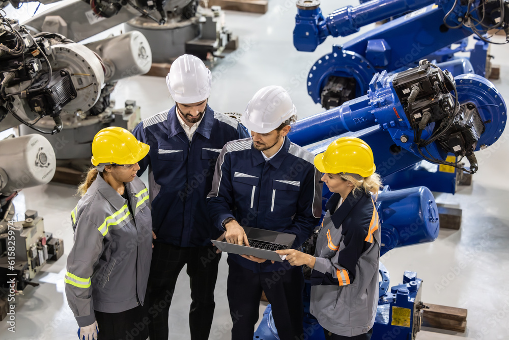 Fototapeta premium Robotic technical and functional teams work together to monitor performance of software and computer-controlled machine tools. Troubleshooting, upgrading existing program to make them more efficient.