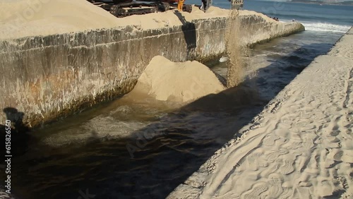 Excavator machine dredges on Ipanema Beach