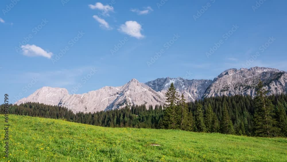 Timelapse video of a panoramic view in the Austrian Alps with mountains, trees and a flower meadow. Ehrwalder Alm, Tyrol, Austria. Timelapse video of a panoramic view in the Austrian Alps with mountains, trees and a flower meadow. Ehrwalder Alm, Tyrol, Austria.