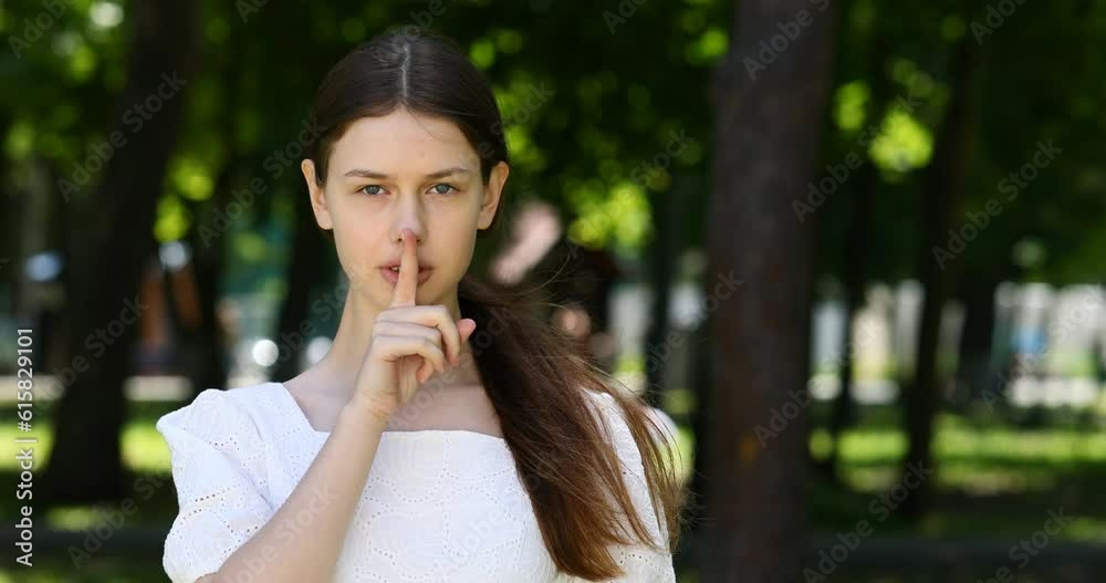 young beautiful girl shows silence sign young beautiful girl shows silence sign