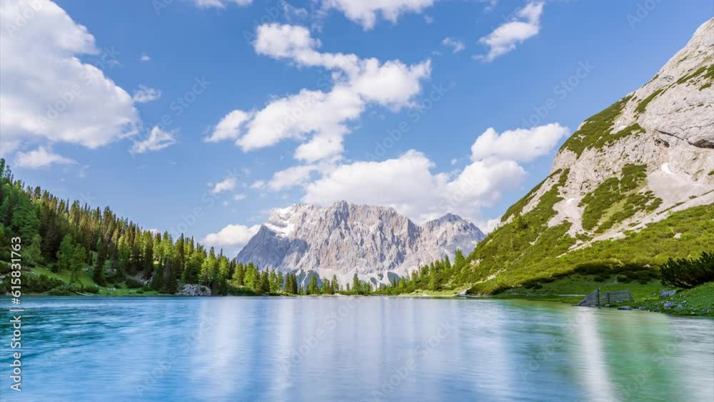 Timelapse video of a crystal clear alpine lake with a mountain range in ...
